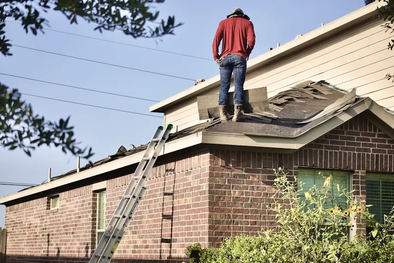 Professional roofer working on a residential roof in Laurel Wood
